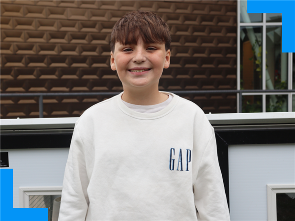  Bronx Hawkins smiles for the camera while standing outside the AgAcademy building.